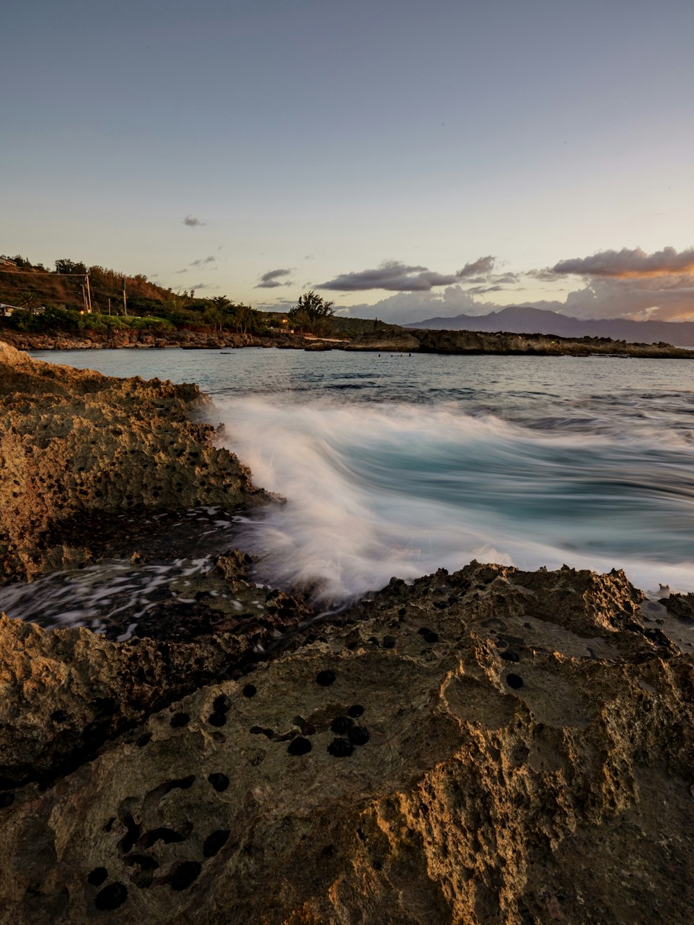 water waves hitting rocks during daytime