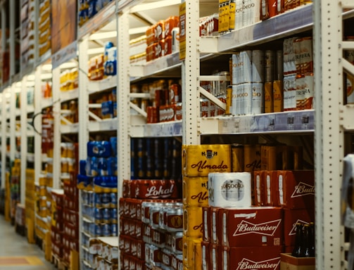 red and white labeled cans on shelf