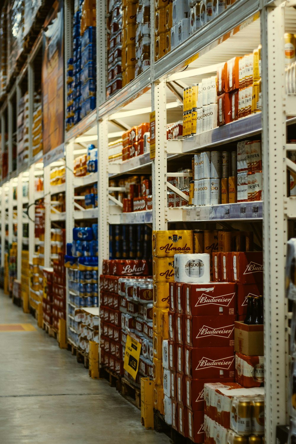 red and white labeled cans on shelf