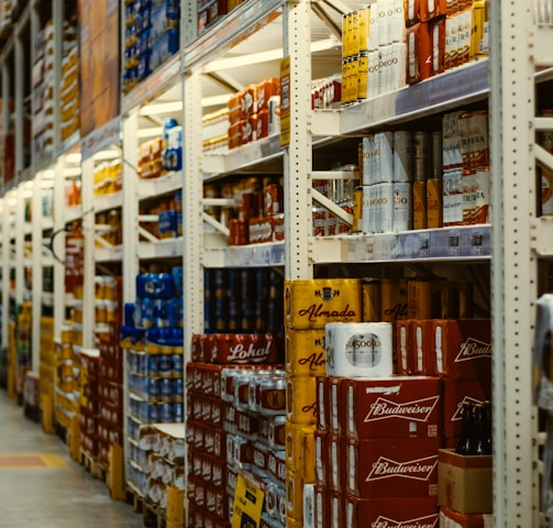 red and white labeled cans on shelf