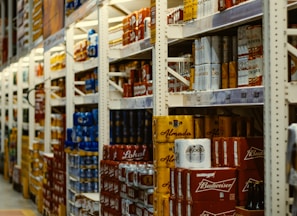 red and white labeled cans on shelf