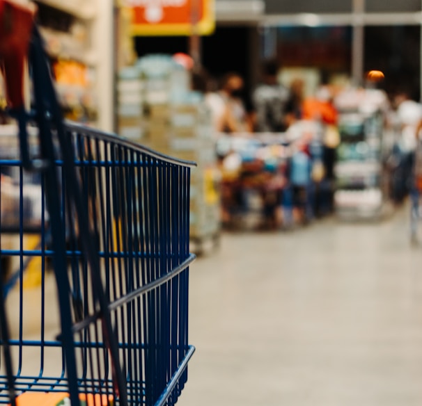 blue shopping cart on street during daytime