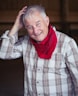 man in white and black plaid dress shirt wearing red scarf