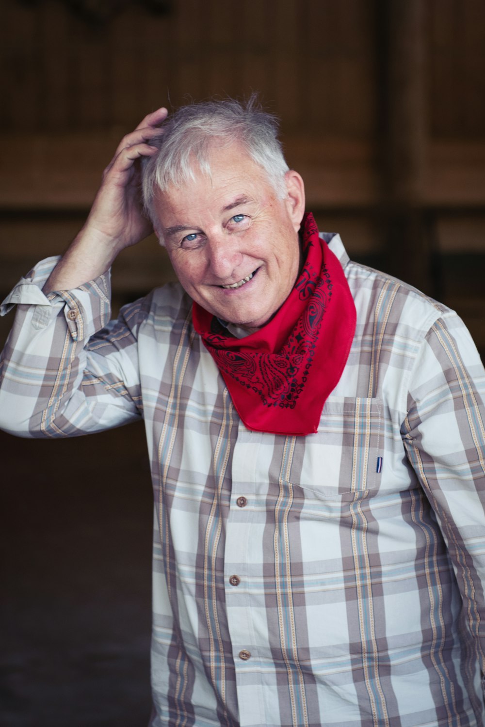 man in white and black plaid dress shirt wearing red scarf