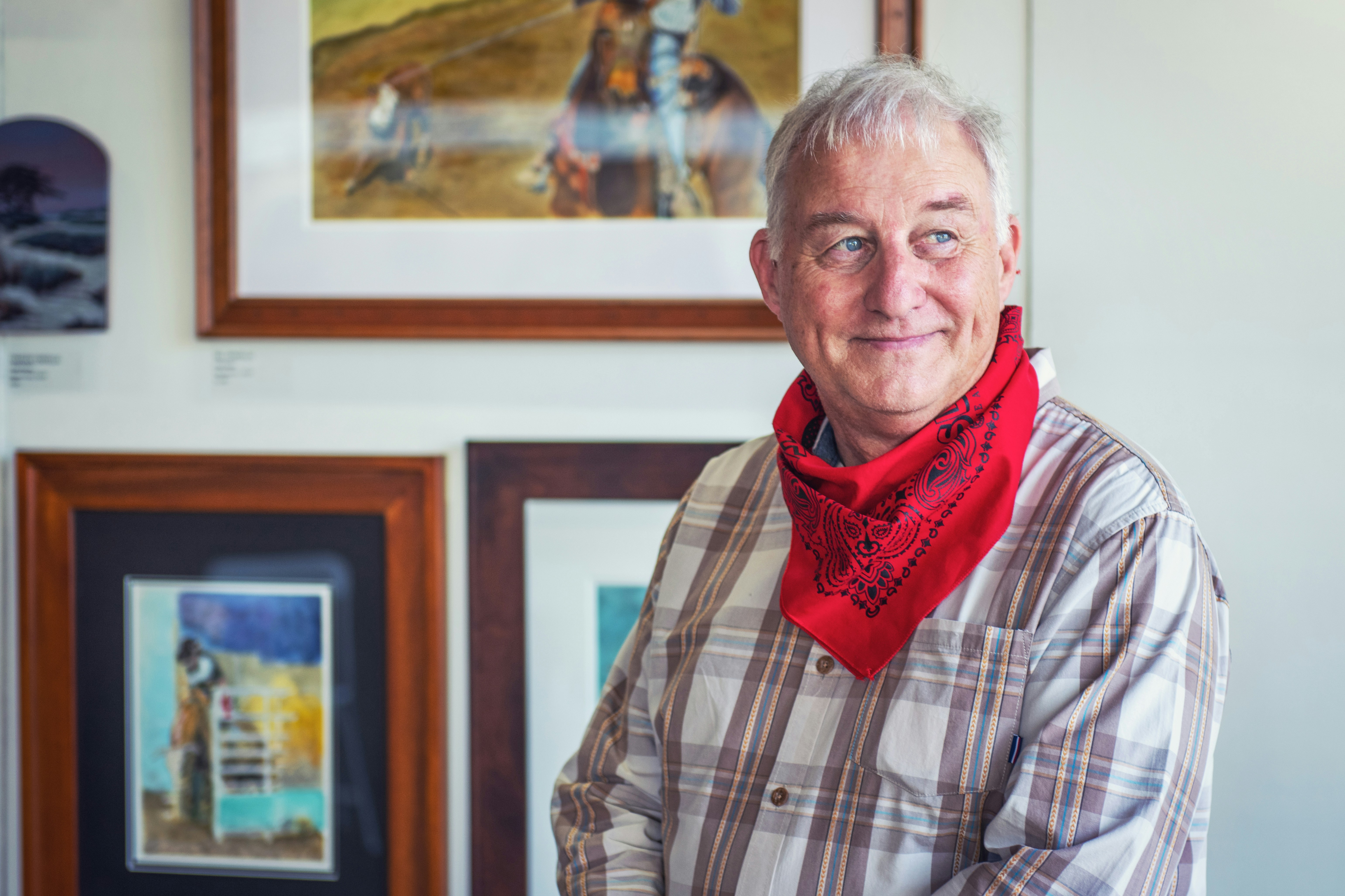 man in gray and white plaid dress shirt and red scarf