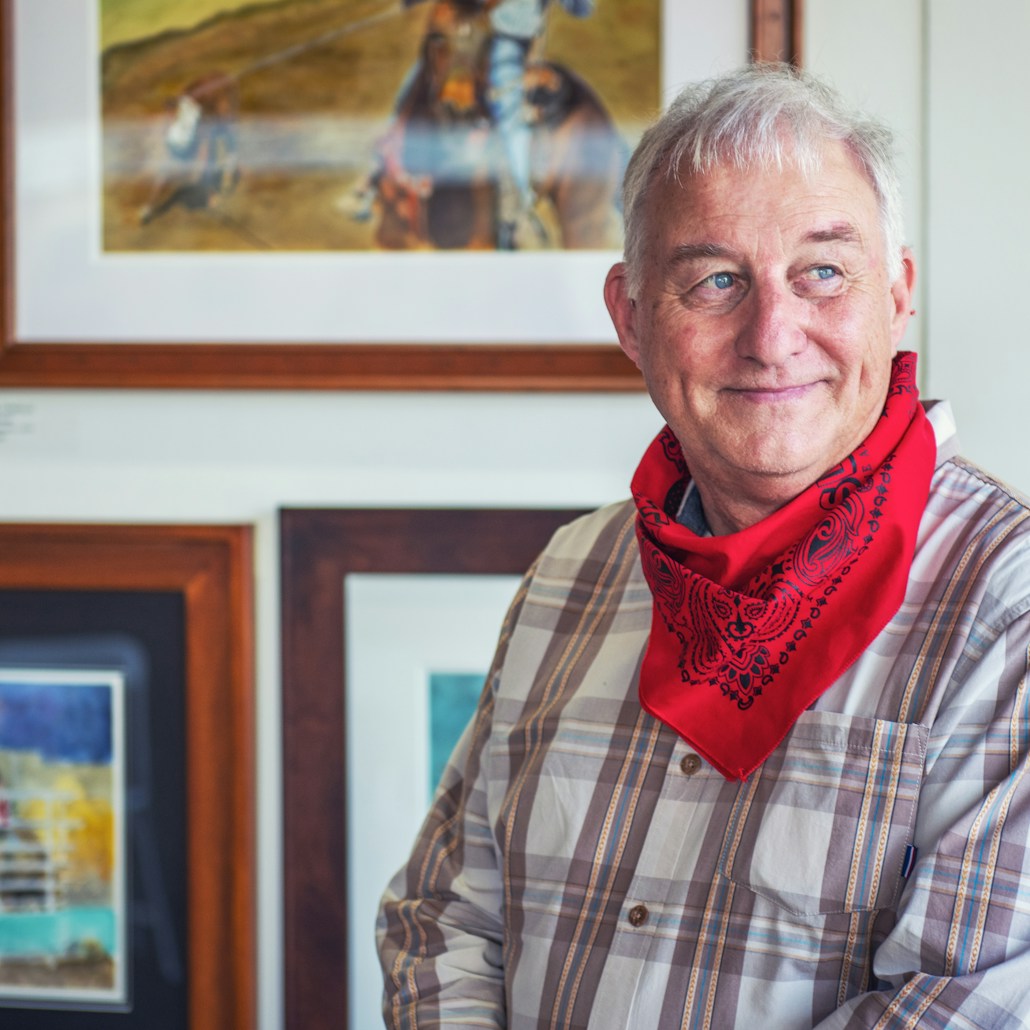 man in gray and white plaid dress shirt and red scarf