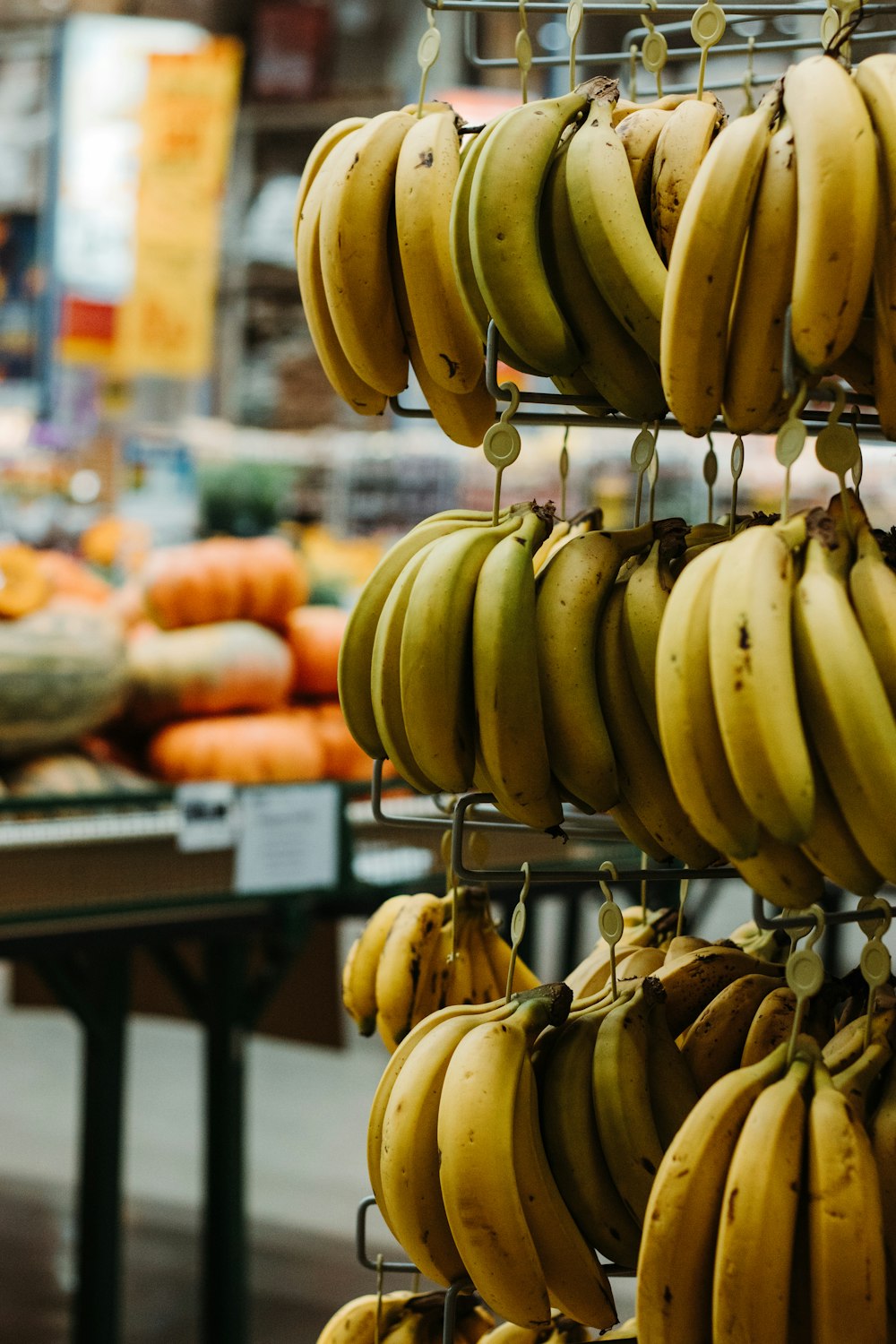 yellow banana fruit on black metal rack