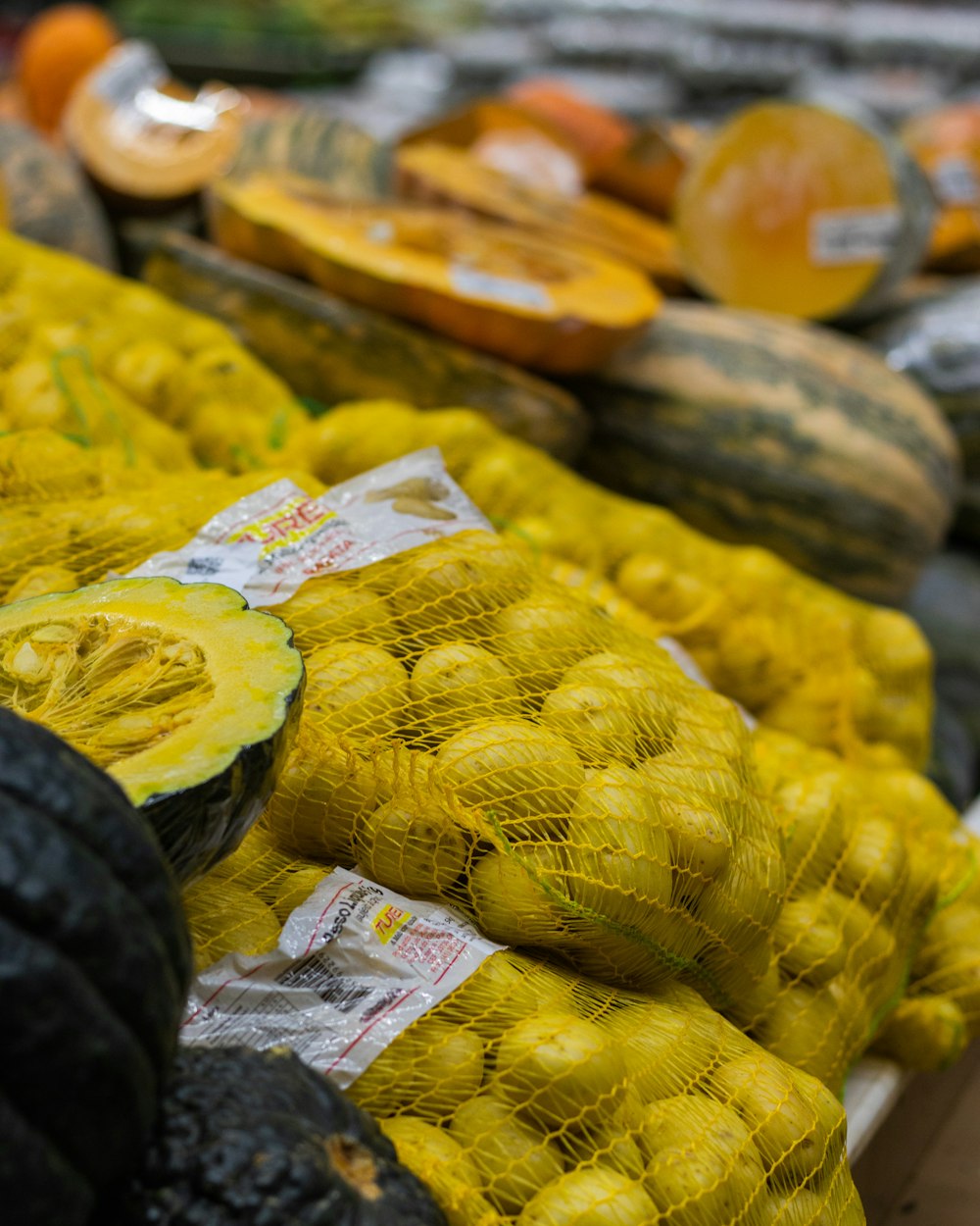 yellow and green fruits on white plastic bags