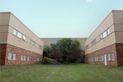 brown concrete building near green grass field during daytime