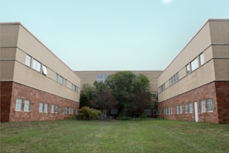 brown concrete building near green grass field during daytime