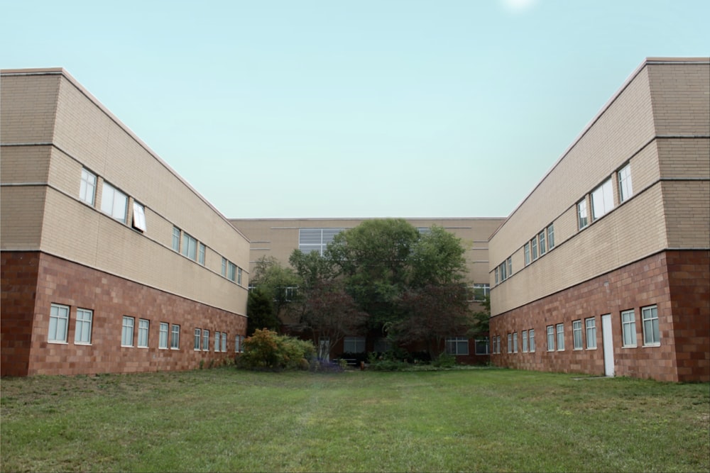 brown concrete building near green grass field during daytime