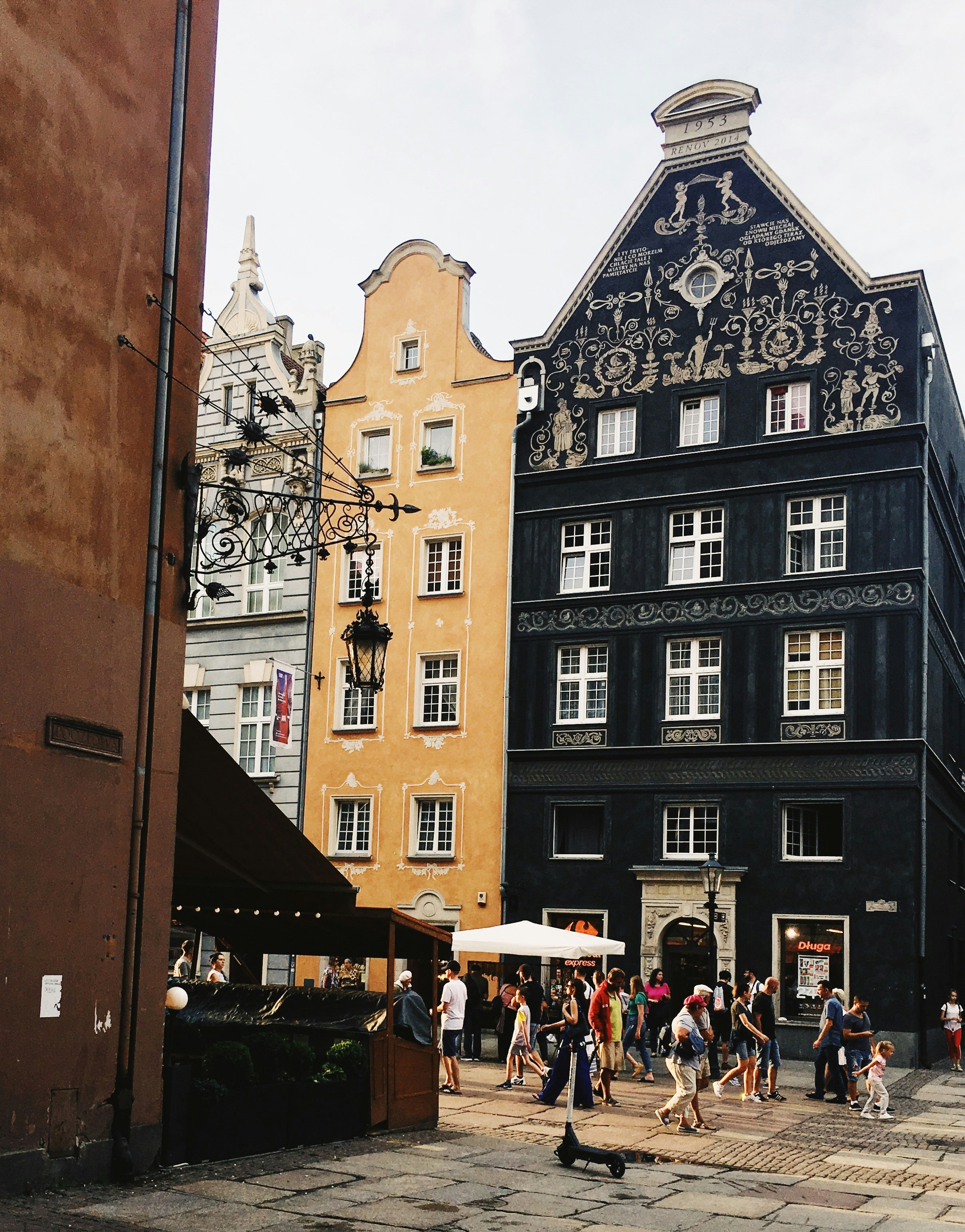 people walking on street near black concrete building during daytime