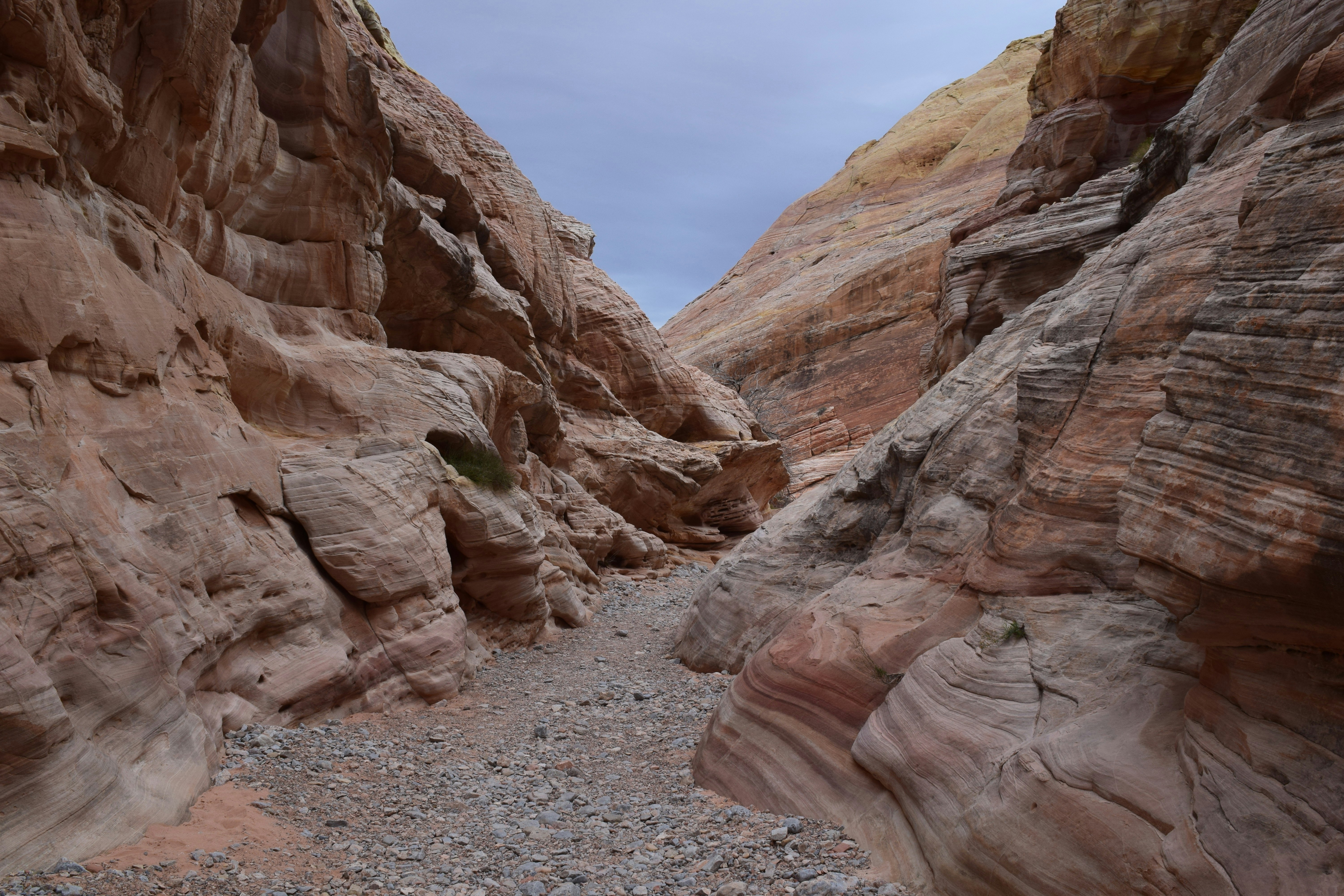 brown rocky mountain under white clouds during daytime