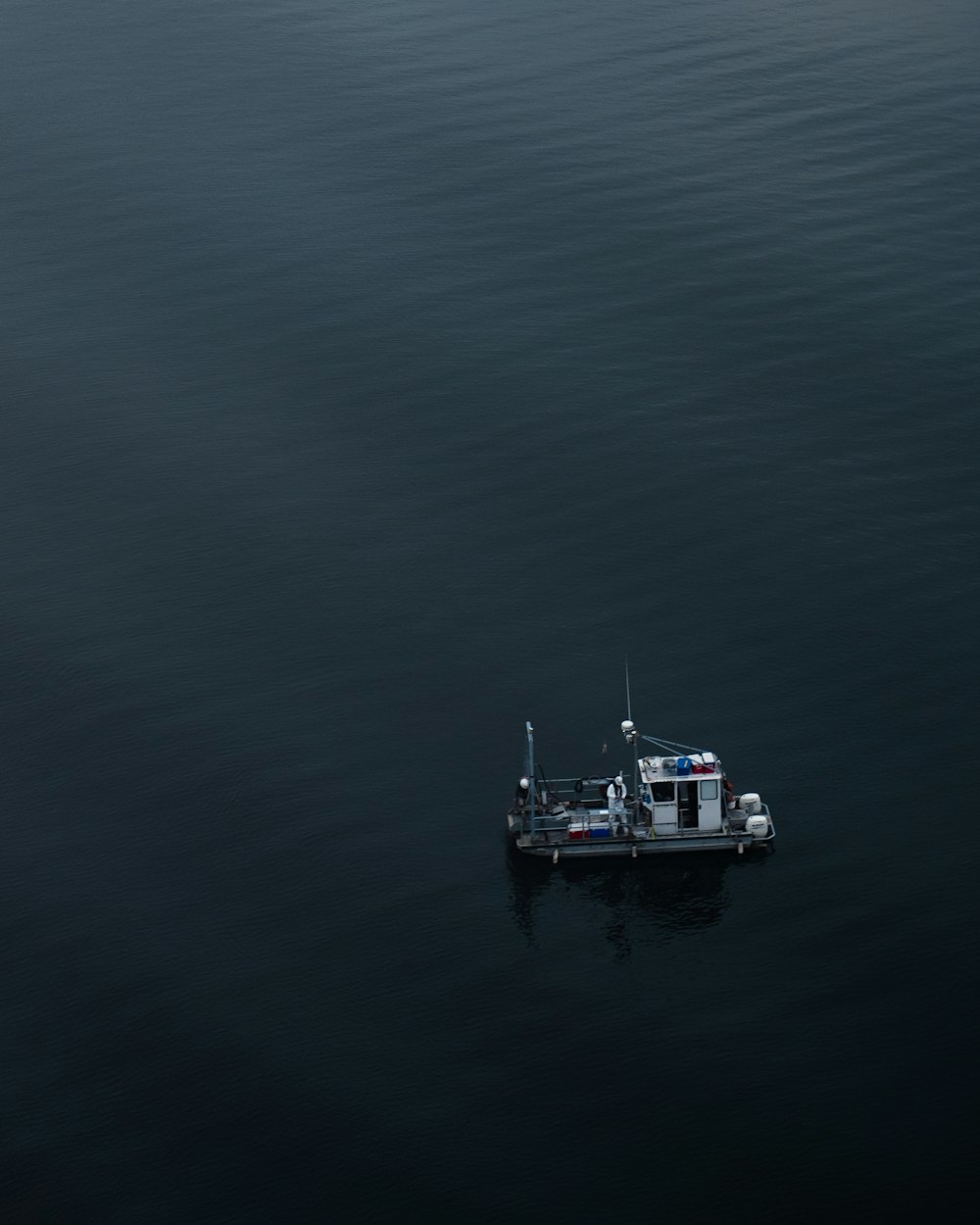 white and black boat on body of water