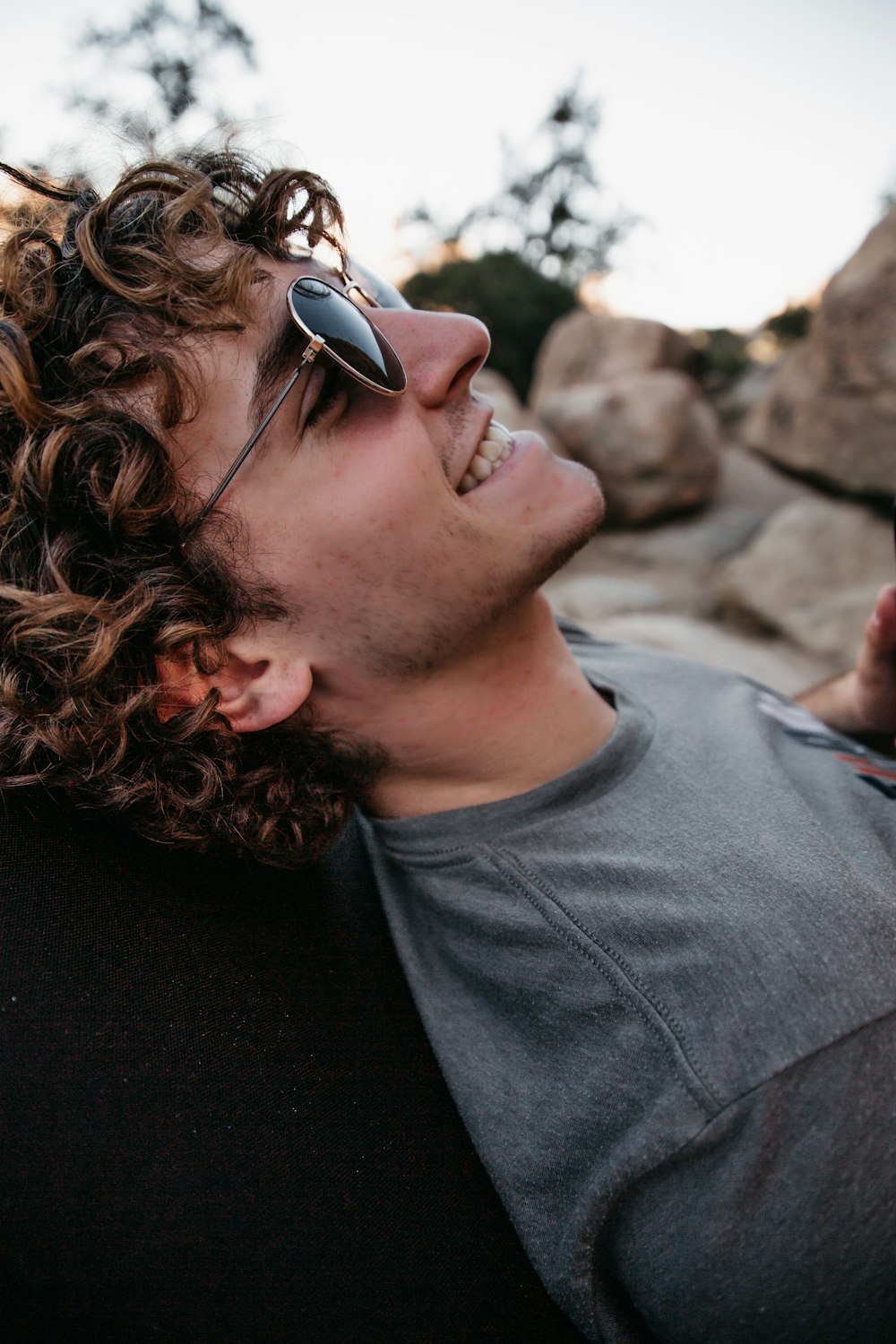 man in black crew neck shirt wearing black sunglasses