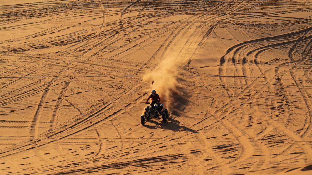 man riding motorcycle on snow covered field during daytime