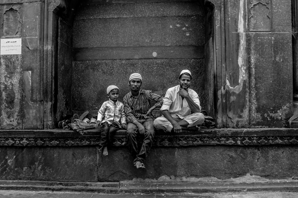 2 men sitting on concrete bench