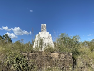 Close-up of a lot boundary marker with natural Panamanian landscape.