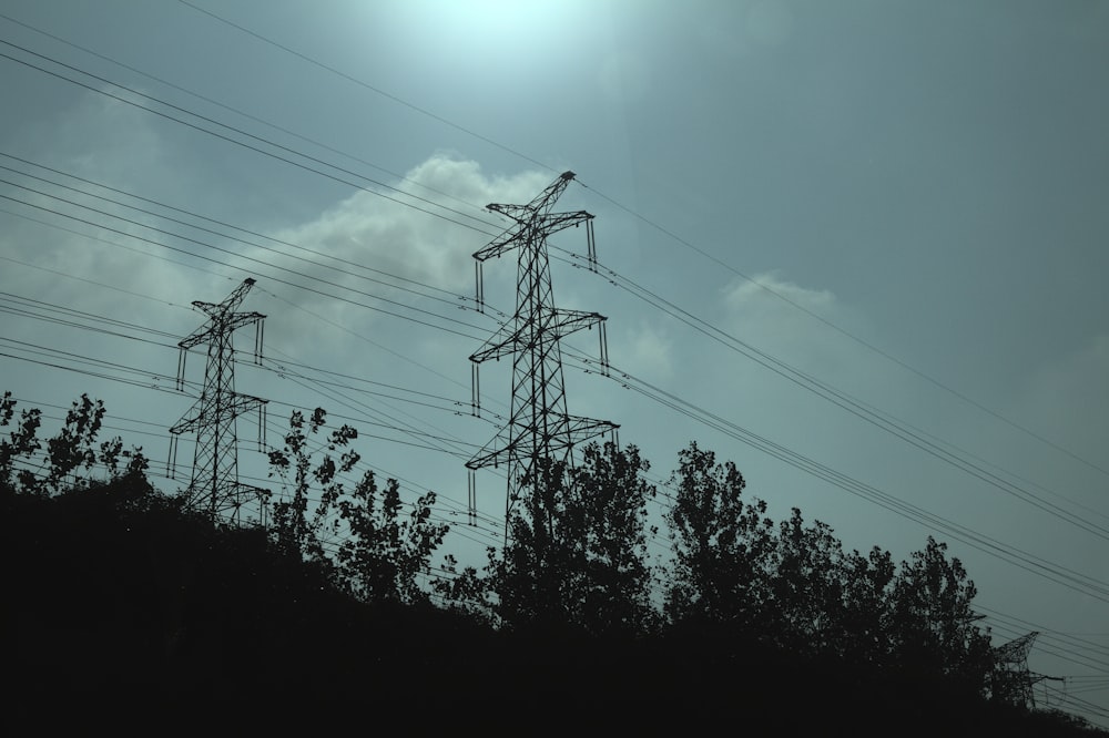 black electric post under blue sky