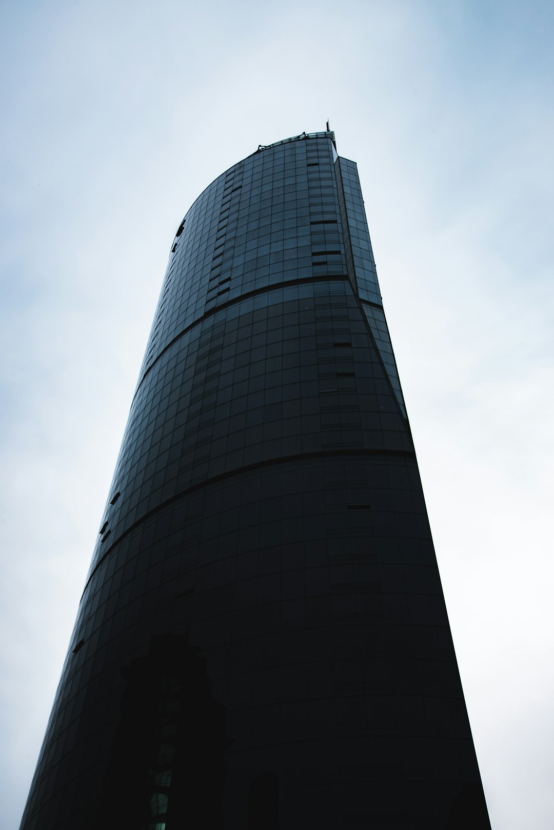 black high rise building under white sky during daytime