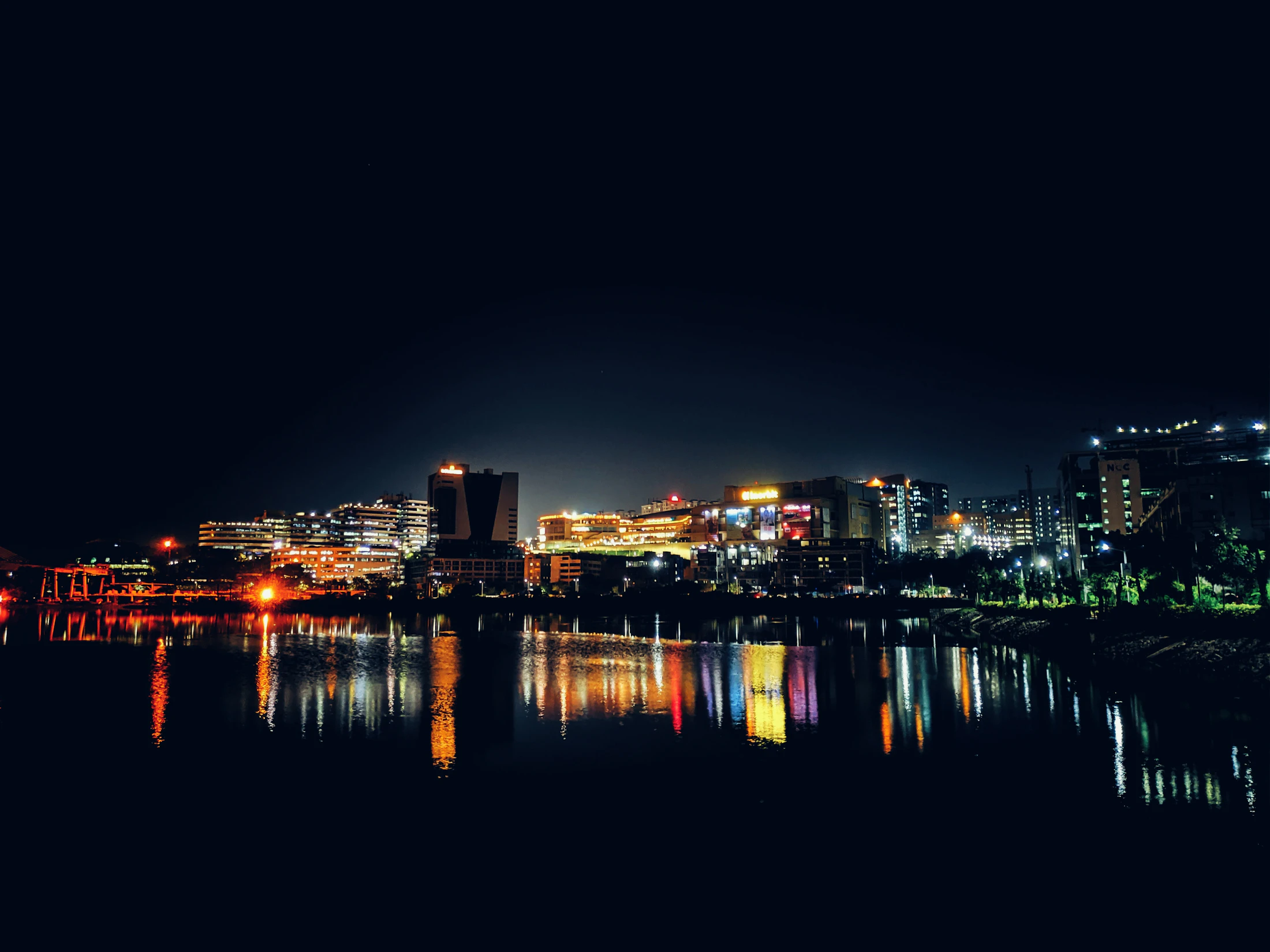 Hyderabad skyline at night across Durgam Cheruvu