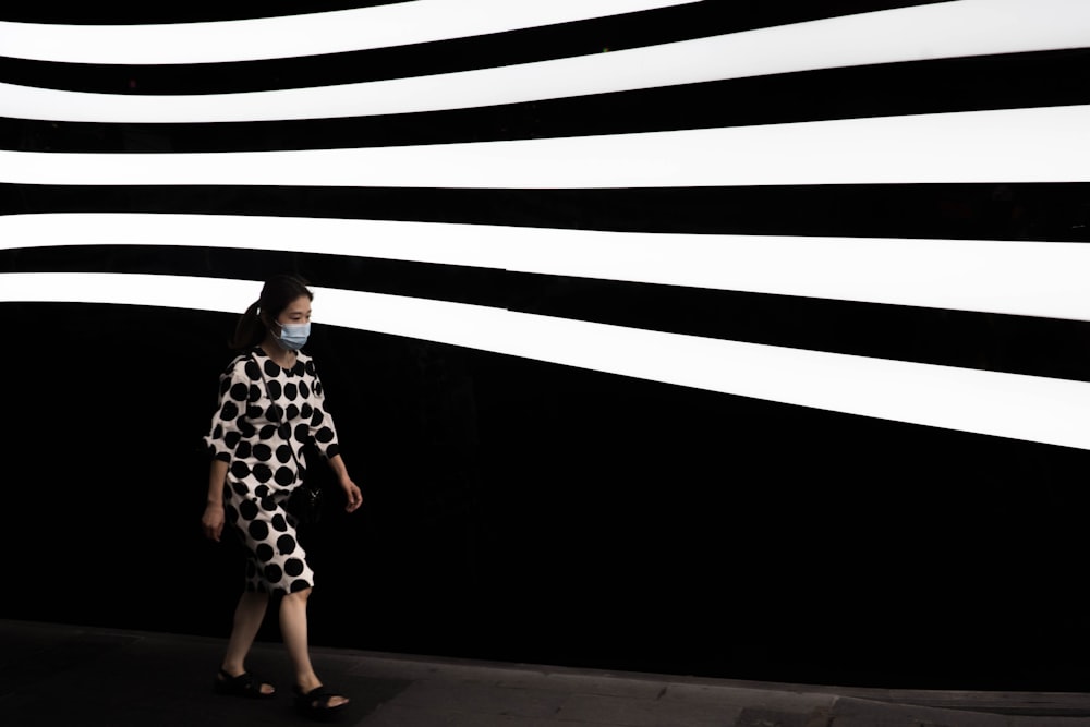 woman in black and white dress standing on the hallway