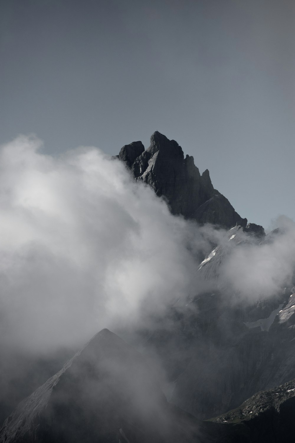 black and white mountains under white clouds