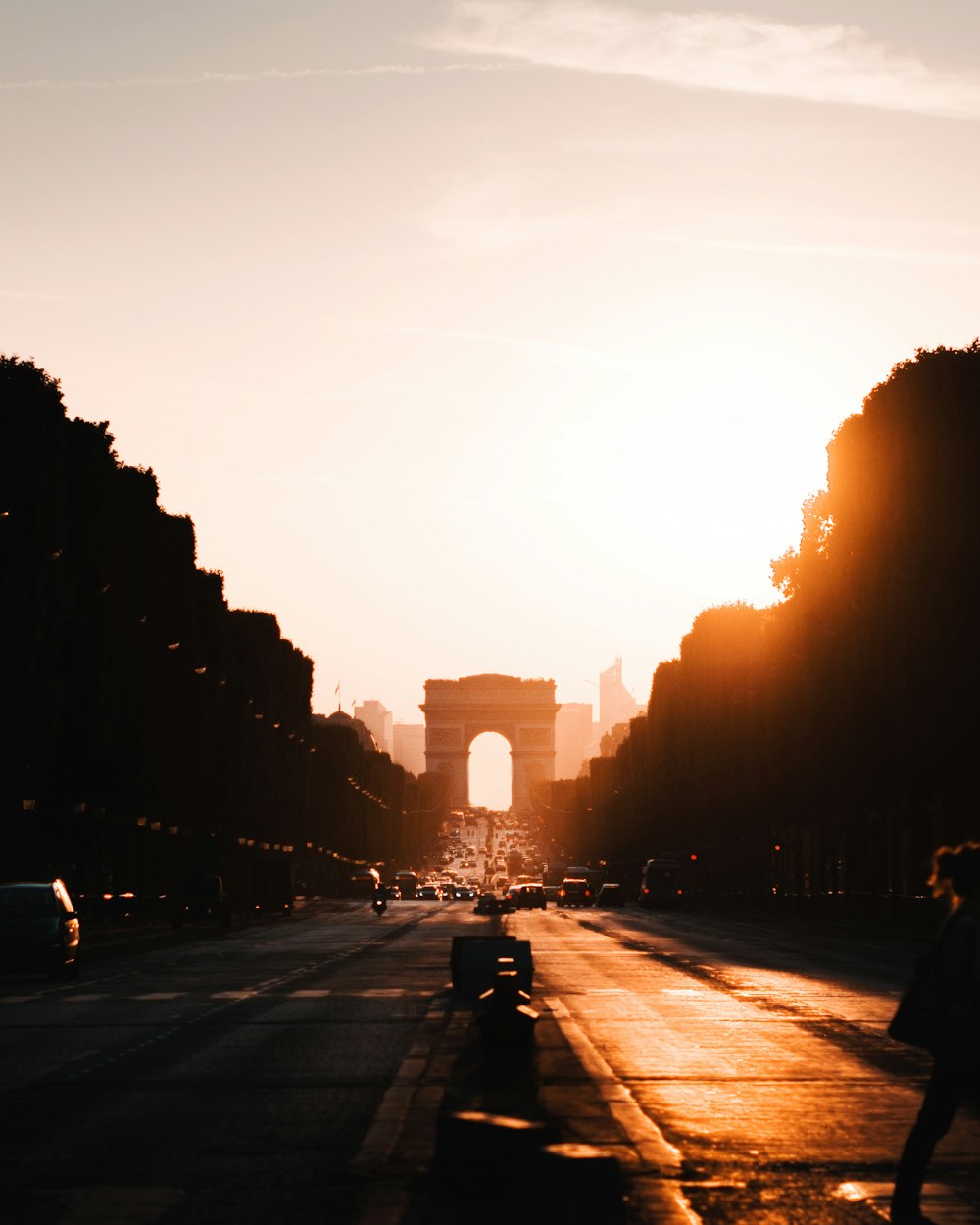 people walking on road during sunset