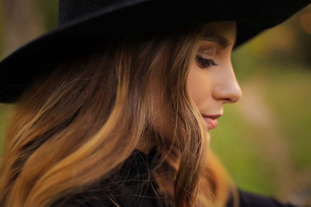 woman in black hat looking to the left