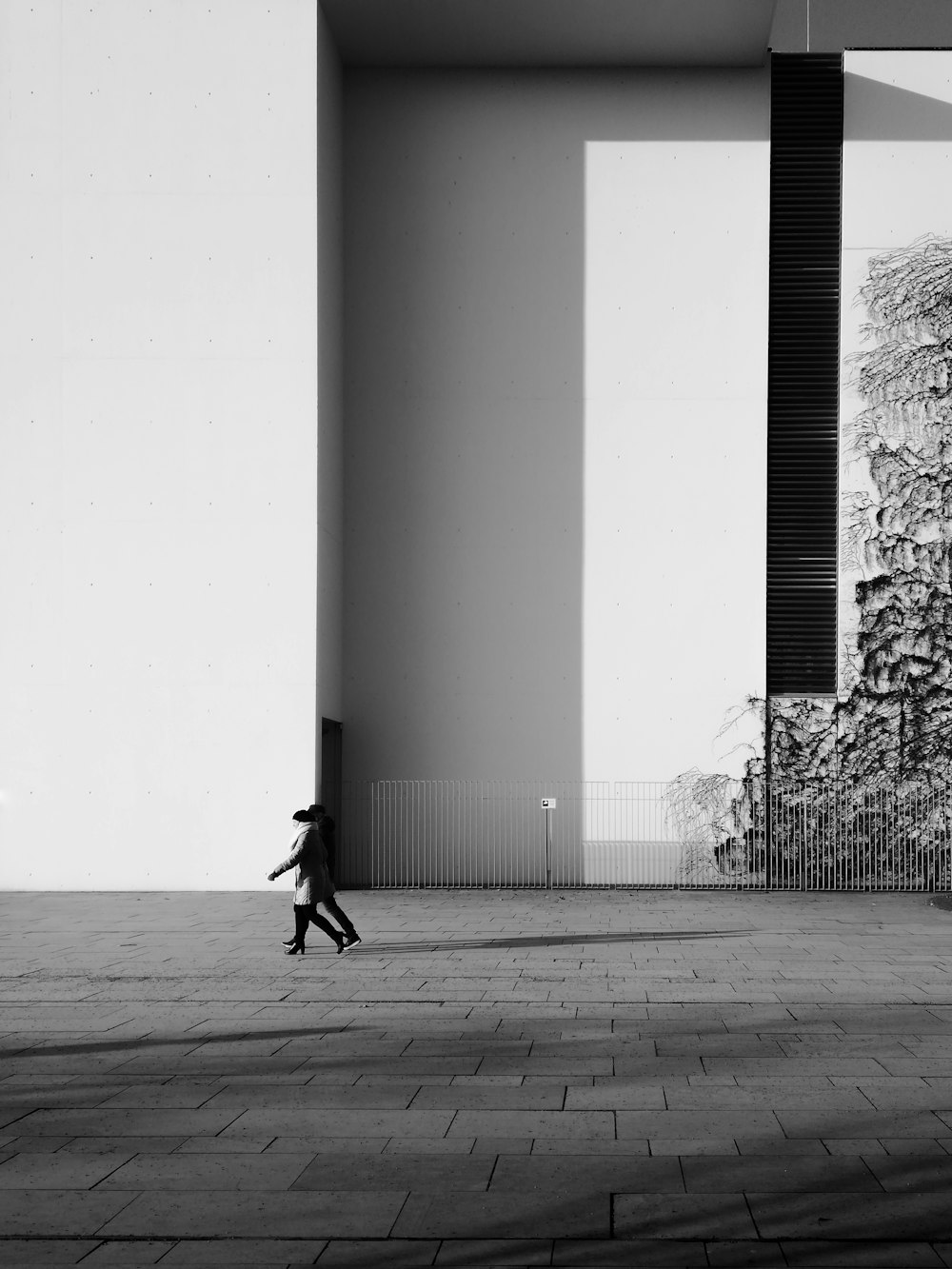 person walking on sidewalk near building