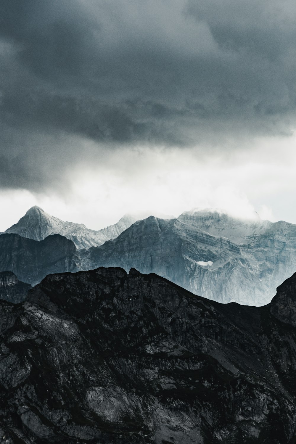 snow covered mountain under cloudy sky