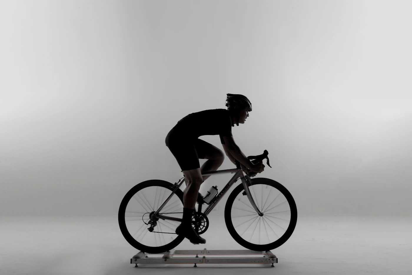 A cyclist resting beside their bike, taking in the view on a calm easy day