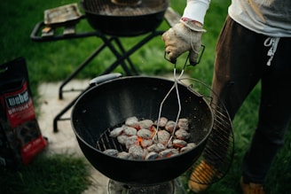 person cooking meat on black round pan