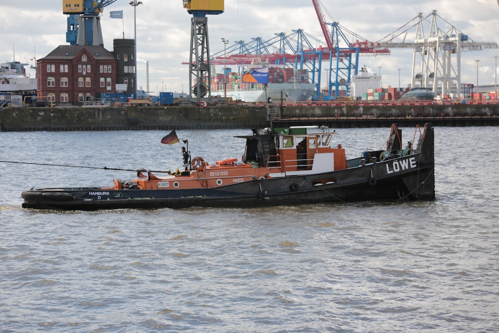 red and black boat on sea during daytime