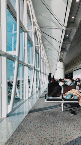 An airport terminal seating area equipped with cushioned flooring mats to ease traveler fatigue.