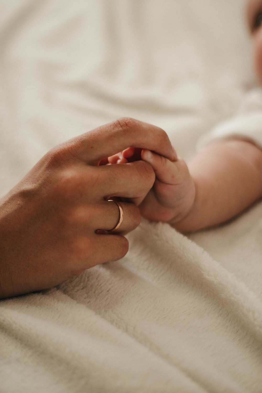 person holding babys hand