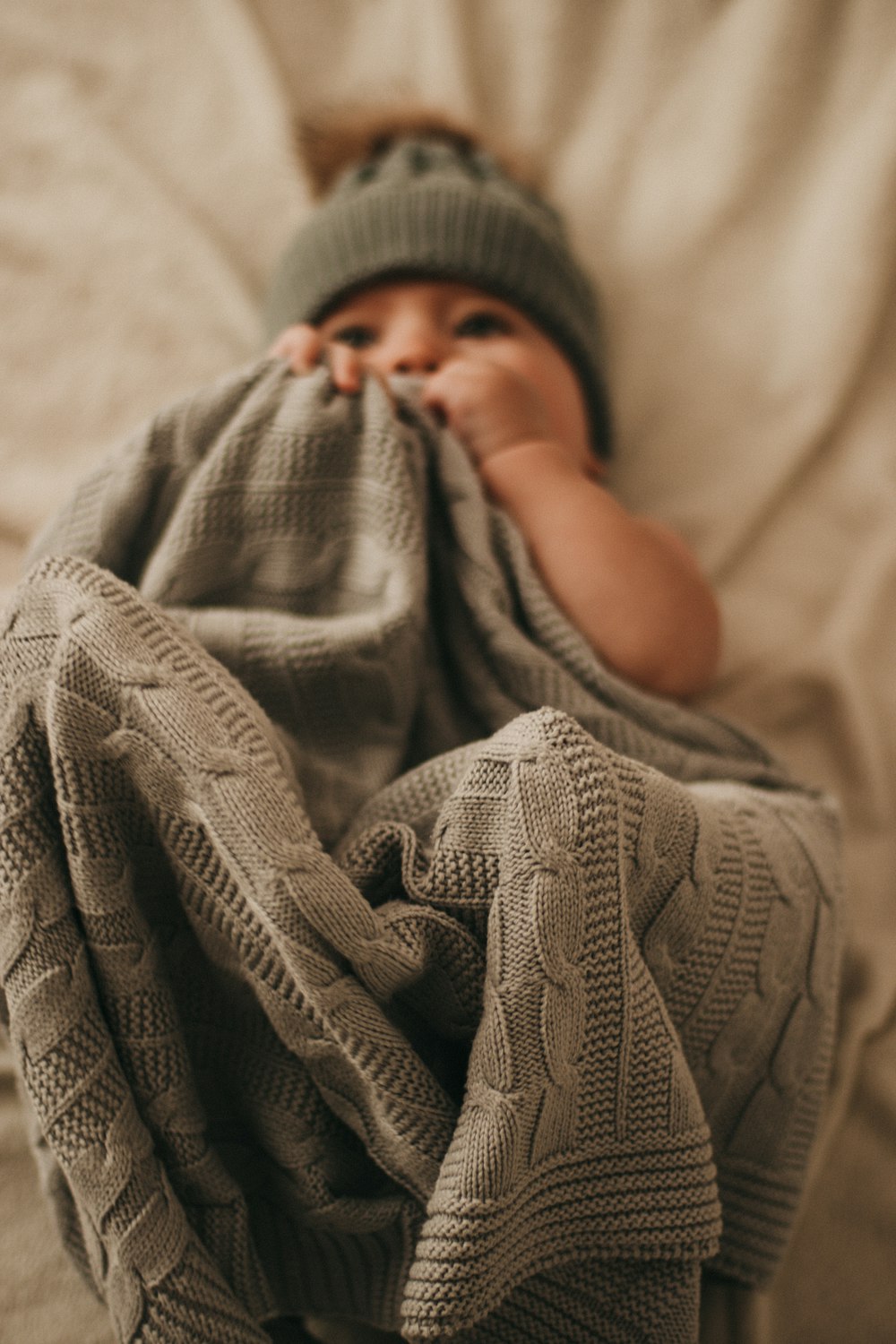 baby in gray knit cap