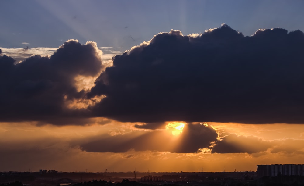 silhouette of mountain under cloudy sky during sunset