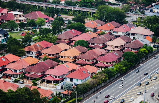 cars on road near houses during daytime in Petaling Malaysia