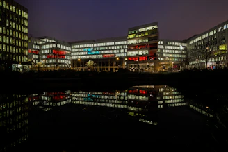 A bright, secure commercial building illuminated by floodlights at dusk, showcasing lumateqh's expertise.