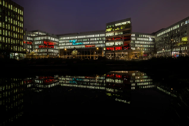 A vibrantly lit office building in Muscat at dusk, symbolizing the dynamic spirit of Live Berry Trading SPC.