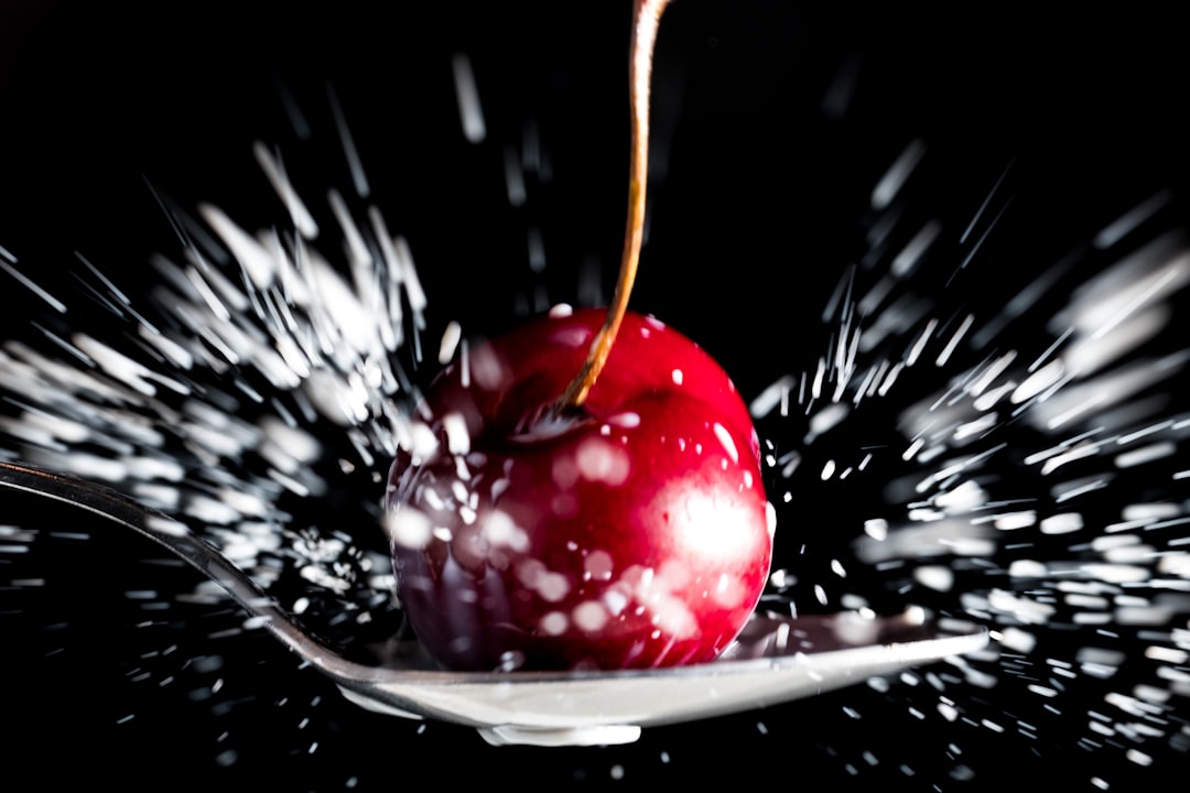 red cherry on white ceramic plate