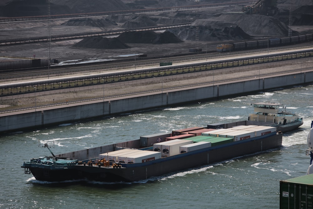 blue red and green cargo ship on body of water during daytime