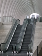 gray escalator inside white building