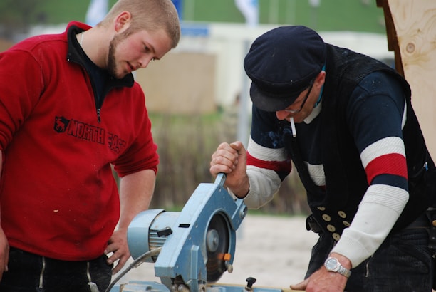 A skilled tradesman in a blue uniform using power tools on a modern home improvement project.