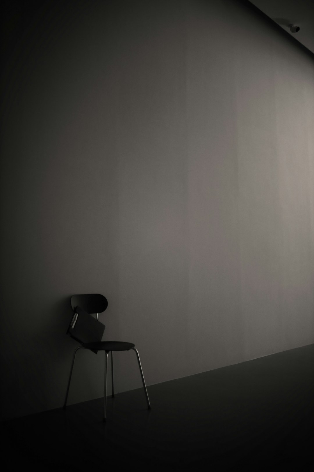 black chair beside white wall