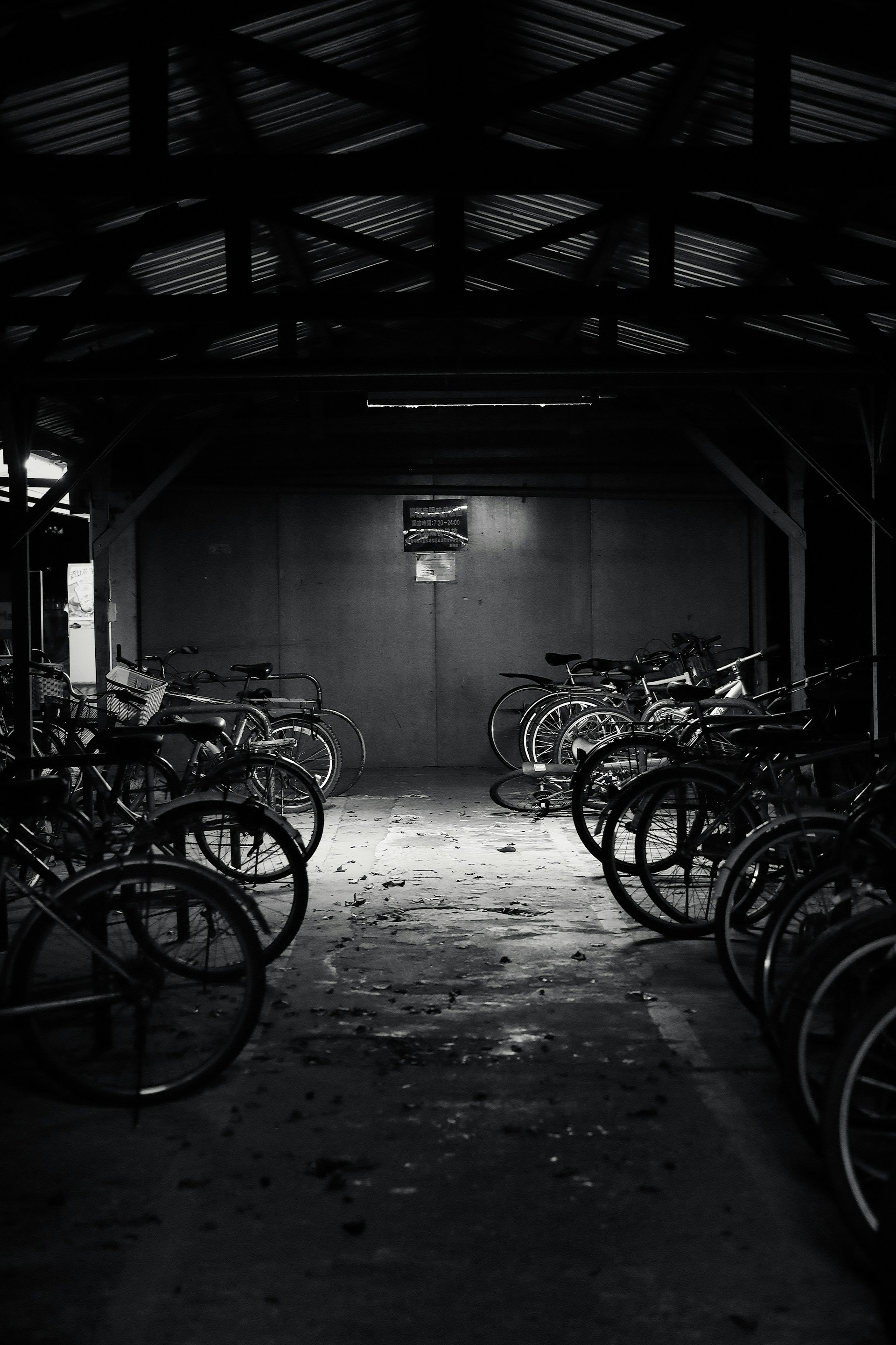 grayscale photo of bicycles in a garage