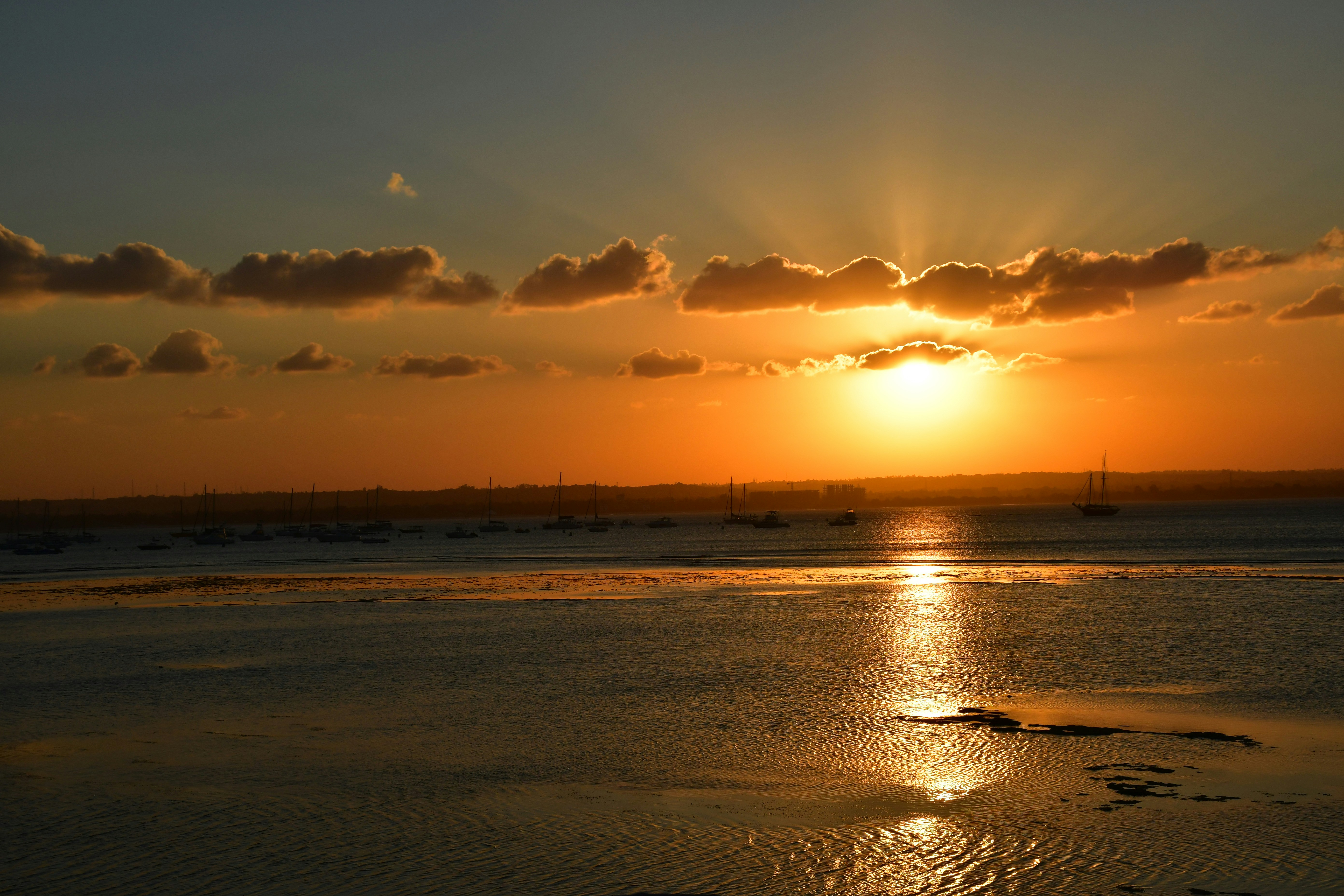 body of water under cloudy sky during sunset