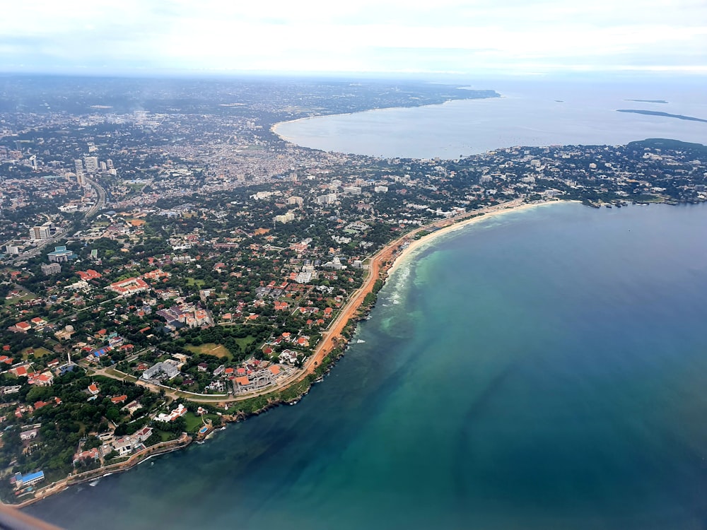 aerial view of city buildings and body of water during daytime