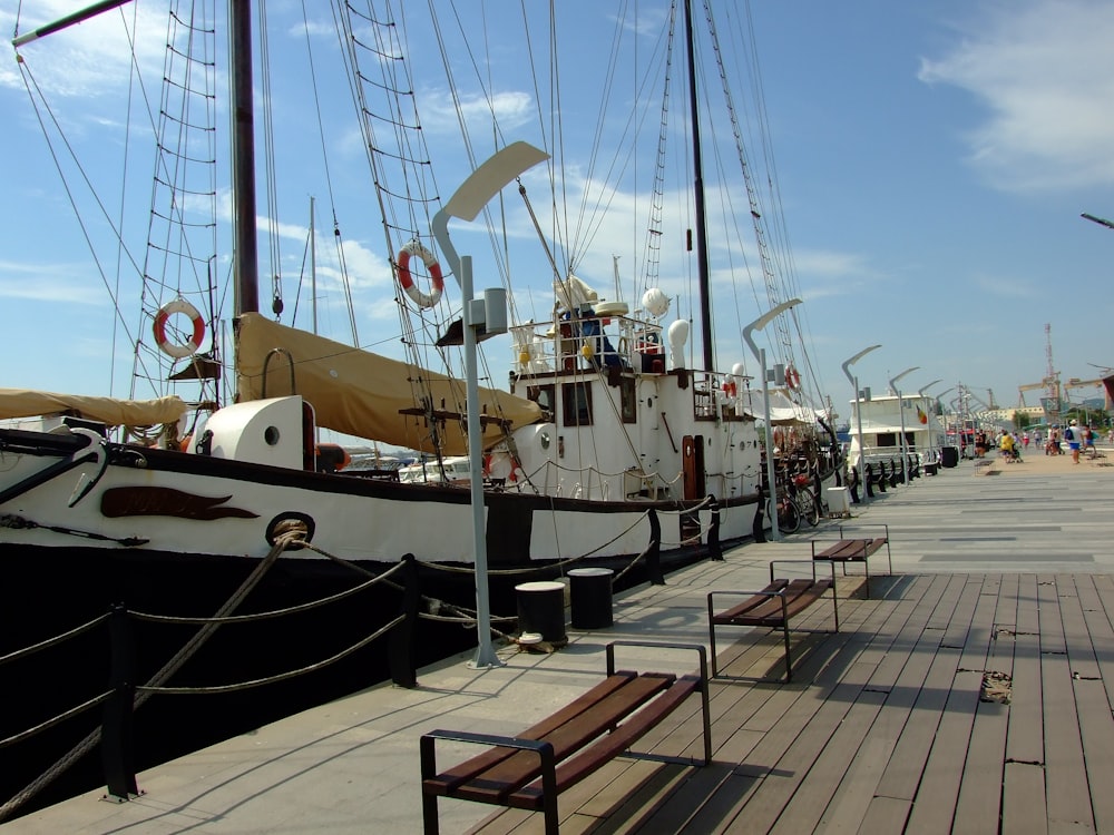 white and black boat on dock during daytime